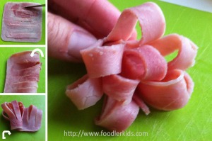 1) Slice the ham into strips but do not cut through the ends 2) fold the ham in half 3) roll the ham.